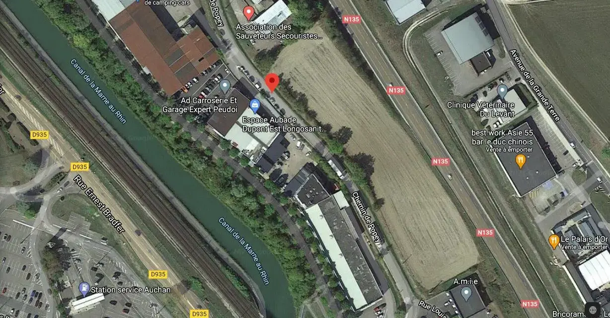 Vue aérienne de Bar-le-Duc : canal, route N135, bâtiments et terrains.